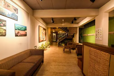 a lobby of a hotel with couches and a staircase at SAFARI QUEST in Mysore