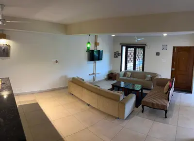 a living room with a couch and a table at SAFARI QUEST in Mysore