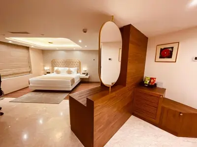 a bedroom with a bed and a large mirror at Dimora Kozhikode in Kozhikode