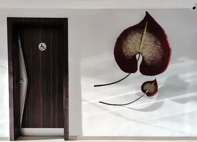 a wall with a piece of fruit next to a door at Zone Connect by The Park Coimbatore in Coimbatore
