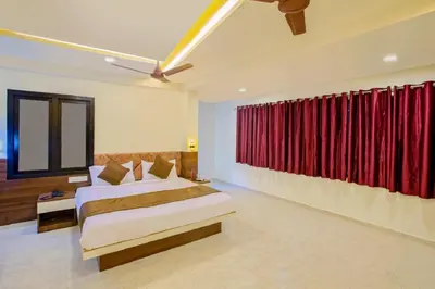 a bedroom with two beds and a red curtain at IVY RESIDENCY in Coimbatore