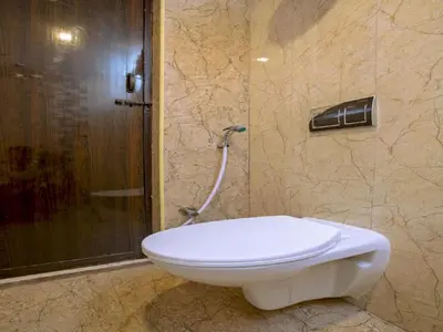a bathroom with a toilet and a shower at IVY RESIDENCY in Coimbatore