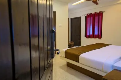 a bedroom with a bed and a red window at IVY RESIDENCY in Coimbatore