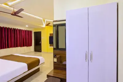 a bedroom with a bed and a red curtain at IVY RESIDENCY in Coimbatore