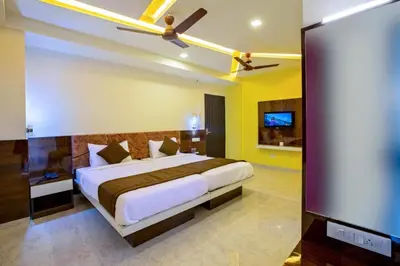 a bedroom with a bed and a flat screen tv at IVY RESIDENCY in Coimbatore