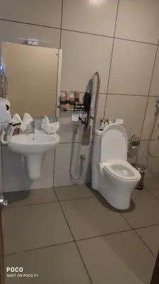 a bathroom with a toilet and a sink at Emperor-Hotel Rachana Continental Pvt Ltd in Kizhake Chālakudi