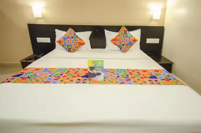a bedroom with a bed with colorful tiles on it at Hotel Sunshine in Mysore