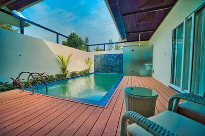 a deck with a swimming pool on a house at Jungle Bay Resorts & Spa in Wayanad