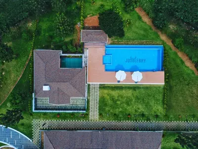 an overhead view of a house with a blue building at Jungle Bay Resorts & Spa in Wayanad