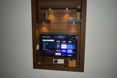 a television in a room with a wall at Ben's Villa Kannur ! in Kannur