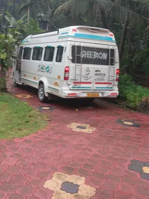 a white van parked on a red brick driveway at Ben's Villa Kannur ! in Kannur