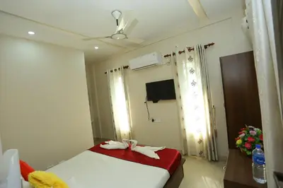a bedroom with a bed with towels on it at Hotel Innate Inn in Alwaye