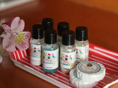 a group of four bottles of hair care products on a tray at The Byke Sunshine Grand in Ooty