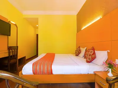 a bedroom with a bed with a yellow wall at The Byke Sunshine Grand in Ooty