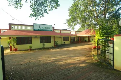 a building with a gate in front of a street at KTDC Tamarind Kondotty in Kondotti