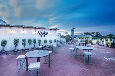 a group of tables and chairs on a patio at Aishwarya Suites in Mysore