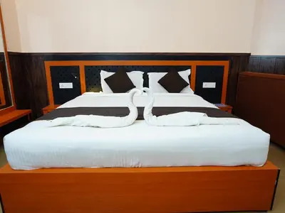 a bed with two swans made out of towels at ABUDHABI RESIDENCY in Palakkad