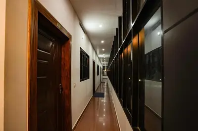 a hallway with a long corridor with wooden doors at Melanna Cherai Beach in Cherai Beach