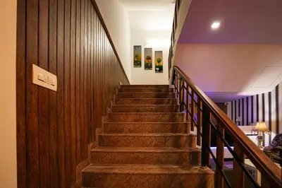 a staircase in a building with wooden walls and wooden stairs at Melanna Cherai Beach in Cherai Beach