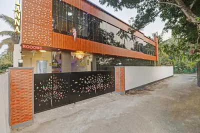 a building with a fence in front of it at Melanna Cherai Beach in Cherai Beach