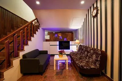 a living room with a couch and a table at Melanna Cherai Beach in Cherai Beach