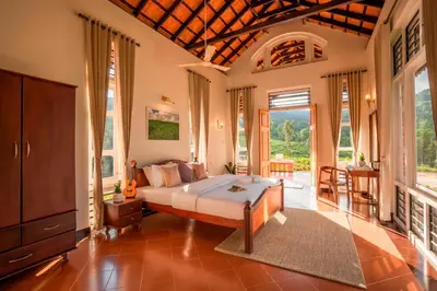 a bedroom with a bed in a room at Zostel Homes Wayanad, Vythiri in Wayanad