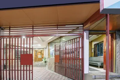 an entrance to a building with red metal gates at Super Townhouse Mysore City Centre Formerly Hotel Mahendra in Mysore