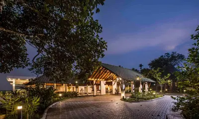 an exterior view of a building at night at GReaT Trails Wayanad by GRT Hotels in Wayanad