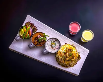 a plate of food with different types of food at GReaT Trails Wayanad by GRT Hotels in Wayanad