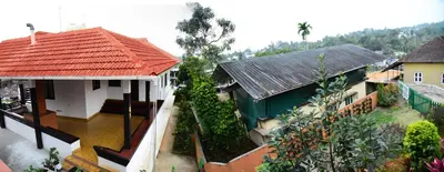 an aerial view of a house with a flooded yard at Nivaasana Bed & Breakfast in Kalpetta