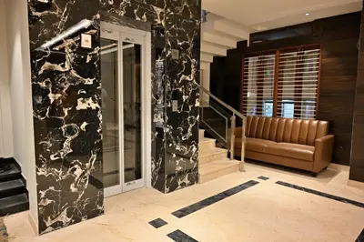a lobby with a black and white wall at Mysore Royale in Mysore