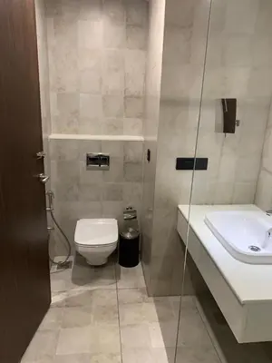 a bathroom with a toilet and a sink at MothiMahal Residency Thrissur in Trichūr