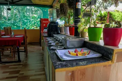 a counter top with a plate of fruit on a plate at D signature Homestay By Lexstays in Kushālnagar