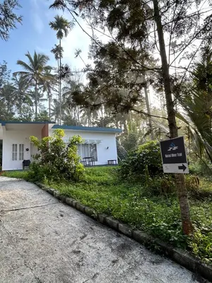a white building with a sign in front of it at Silver Oak By Exuberance Stays (Independent Holiday Home) in Wayanad