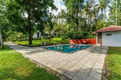 a swimming pool in the backyard of a house at Silver Oak By Exuberance Stays (Independent Holiday Home) in Wayanad