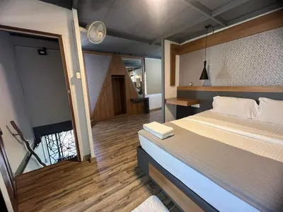 a bedroom with a large bed and a large window at Wild root stay- Aster Chalet in Wayanad