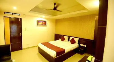 a bedroom with a bed and a ceiling fan at Shastri Paradise opst to KSRTC Bus Stand in Mysore
