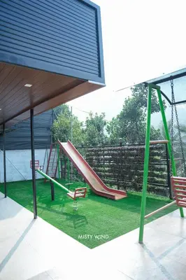 a play area with a slide and a playground at Vythiri Misty Wind Holiday Homes in Vythiri