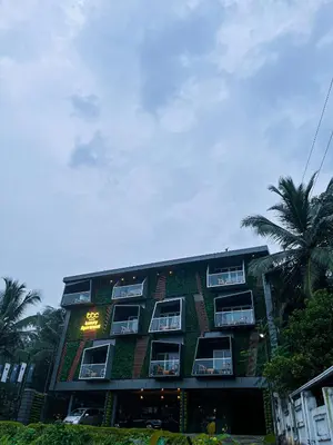 a building with plants on the side of it at BBC Luxury Apartments in Perintalmanna