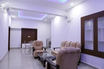 a waiting room with chairs and a table in a room at AP Residency in Wayanad