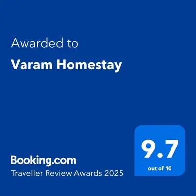 a blue screen with the text awarded to vanham homogeneity at Varam Homestay in Madikeri