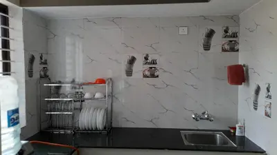 a kitchen with a sink and a counter top at Varam Homestay in Madikeri