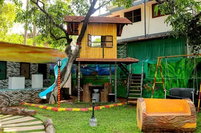a tree house in a yard with a playground at Belljem Homes -your own private resort -1 BR in Trichūr