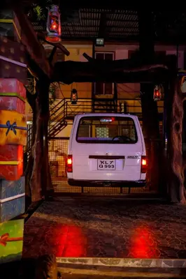 a white car parked in a garage at night at Belljem Homes -your own private resort -1 BR in Trichūr