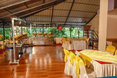 a large room with tables and chairs in it at Belljem Homes -your own private resort -1 BR in Trichūr