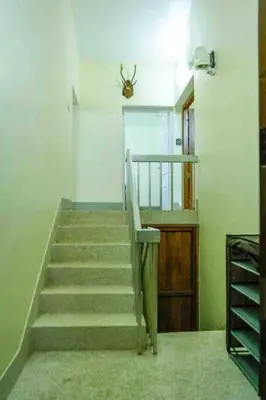 a staircase in a room with a stair case at Belljem Homes -your own private resort -6 BHK B in Trichūr