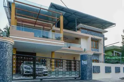 a house with a balcony and a car parked in front at Belljem Homes -your own private resort -6 BHK B in Trichūr