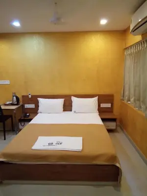 a bedroom with a bed with a sign on it at GRACE RESIDENCY in Tirūr