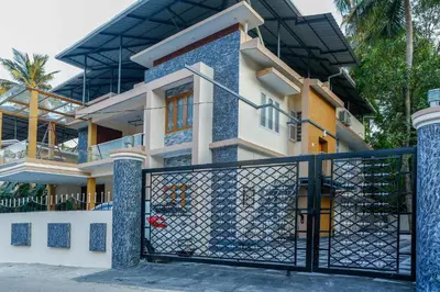 a house with a gate in front of it at Belljem Homes -your own private resort -2 BHK GF in Trichūr