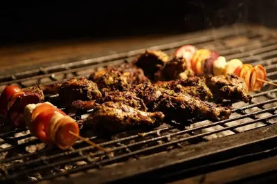 a group of meat and vegetables on a grill at Entire Villa at the Heart of the Wayanad Forest. in Kutta